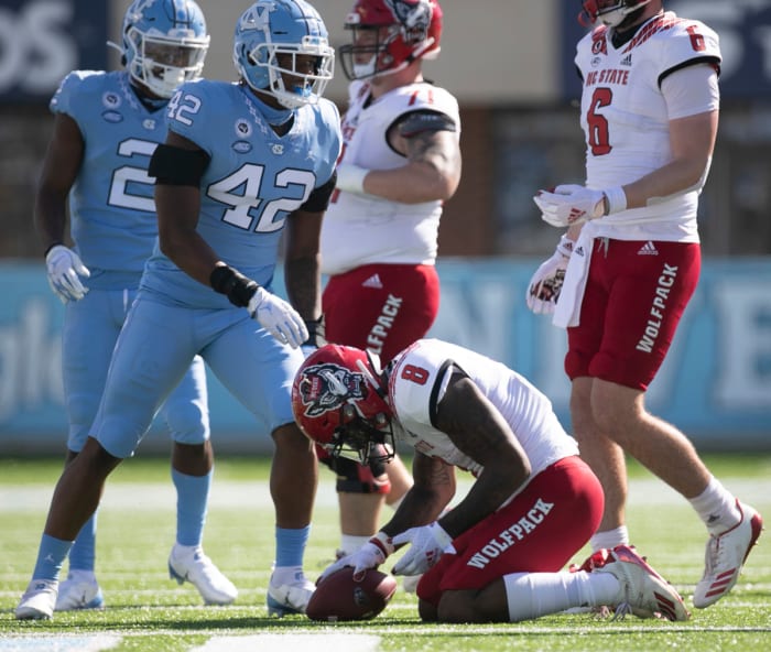 Ricky Person Jr. kneels on the turf after suffering a concussion during the third quarter